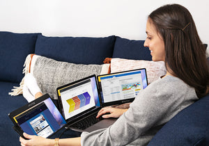 12.5-inch | 14-inch | Swivel | Sidetrak | Monitor Portable | Woman working from home sitting on couch with triple monitor Swivel set up on her lap with browsers and work screens open