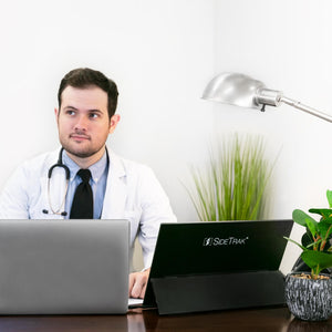 Dr. sitting at an office desk using a Sidetrak Solo portable monitor