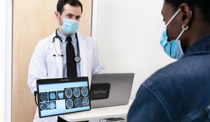 14-inch | Swivel | Sidetrak | monitor for laptop | a doctor standing at a laptop with swivel monitor rotated to face the patient and showing x-rays