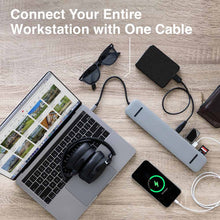 10 Port | Docking Station | SideTrak | 10 Port Docking Station USB-C hub | SideTrak 10-Port 4k USB-C hub sitting on a wood table with an assortment of gadgets attached to it