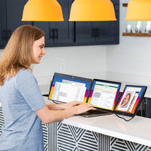 14" | Swivel | Triple | Side trak | Triple Monitor Laptop | woman working at kitchen counter on a sidetrak swivel triple monitor laptop set up