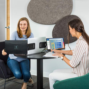 12.5" | Swivel | Triple | SideTrack | Triple Monitor Laptop | two coworkers working at a table while using a swivel 12 triple screen set up with the right screen fully rotated and displaying a presentation